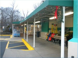 Custom teal storefront awning with white beams