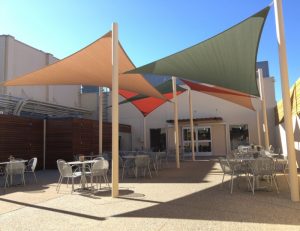 Olive green, tan, and orange sun shade panels for a patio