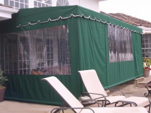 Dark green patio shade awning with clear plastic panels