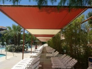 Custom pool awning with red and white fabric