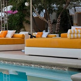 Custom pad cushions with yellow fabric next to a pool