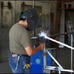 Welding a custom aluminum awning at our shop