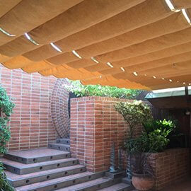 Outdoor retractable awning with tan fabric