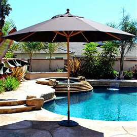 Van Nuys umbrella offering shade next to a beautiful pool