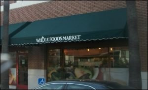 Green custom storefront awnings for Whole Food Market